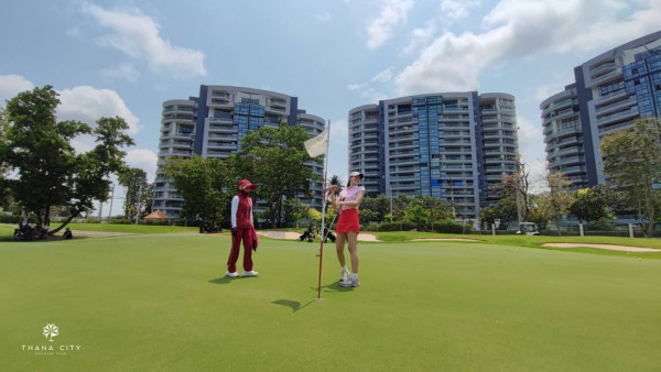 Thana City Country Club 3 people people golfing golf cart golf course and text