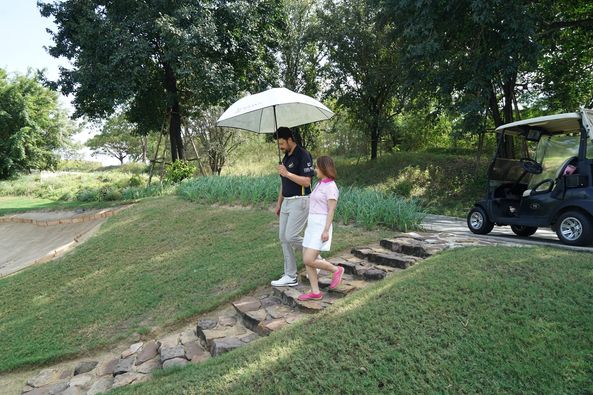 Nikanti Golf Club Nakhon Pathom 2 people people golfing golf cart golf course and grass