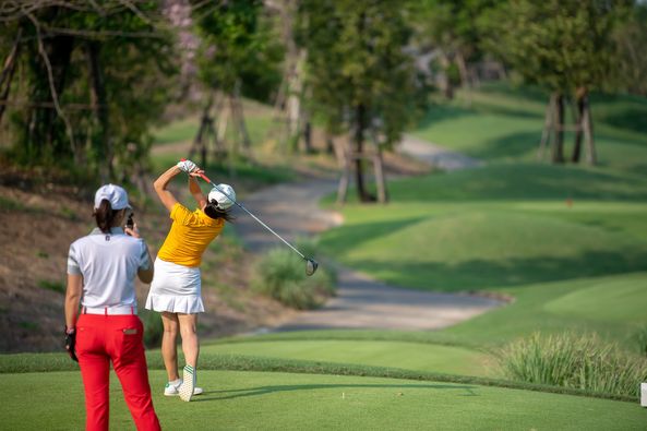 Nikanti Golf Club Nakhon Pathom 2 people people golfing golf course and text