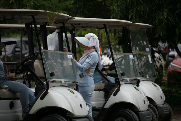 สนามกอล์ฟหริภุญชัย กอล์ฟคลับ 2 people people golfing golf cart golf course and text