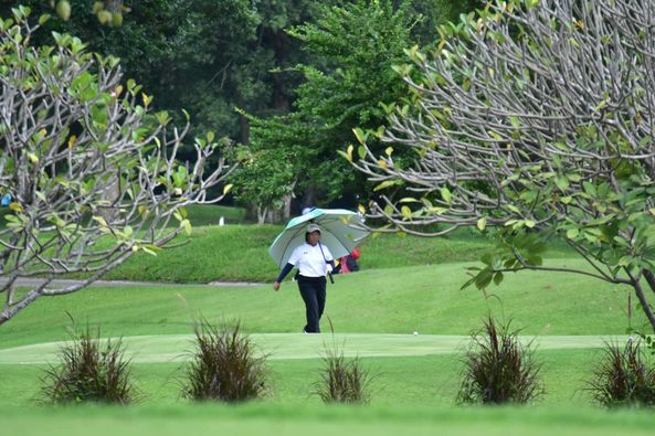 Alpinegolfresort Chiangmai 2 people people golfing golf cart and golf course