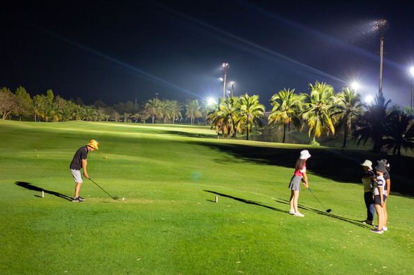 3 people people golfing and outdoors