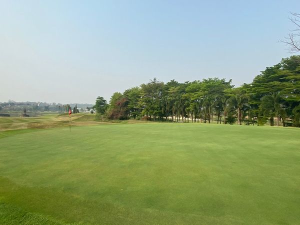 Gassan Khuntan Golf amp Resort Thailand 2 people golf course and grass