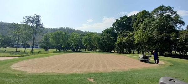 Alpinegolfresort Chiangmai 1 person golfing golf cart grass and golf course