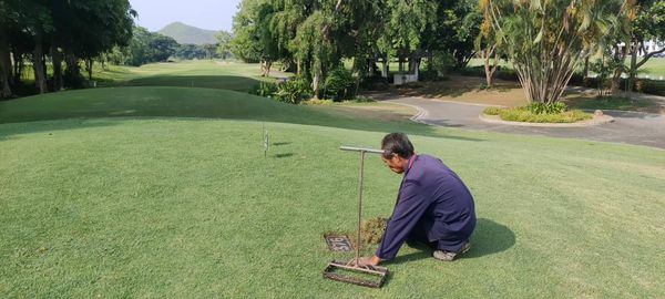 Alpinegolfresort Chiangmai 1 person golfing golf course and grass