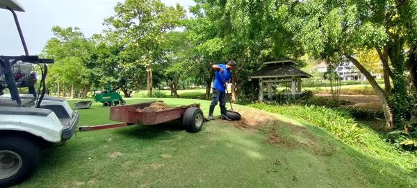 Alpinegolfresort Chiangmai 2 people golf cart grass and golf course