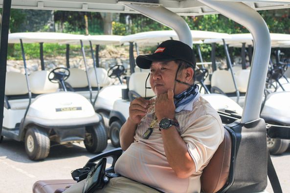 Gassan Khuntan Golf amp Resort Thailand 1 person golfing golf cart and golf course