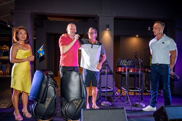 Black Mountain Golf Club 5 people people golfing speaker golf cart saxophone segway and television