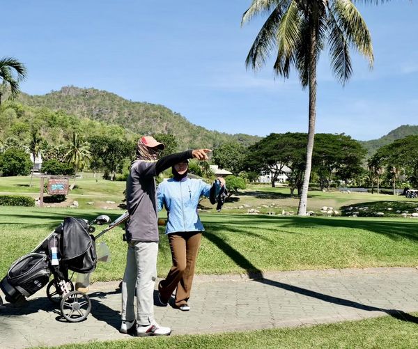 Palm Hills Golf Club amp Residence 2 people people golfing golf cart and golf course