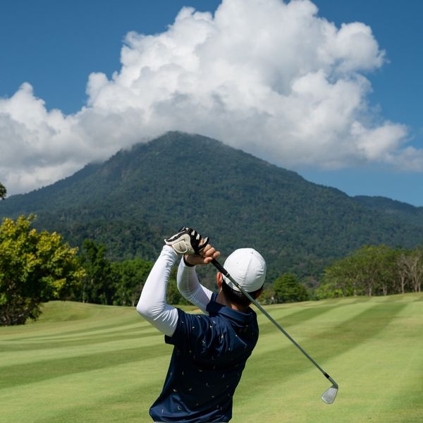 Chatrium Golf Resort Soi Dao Chanthaburi 1 person golfing and golf course
