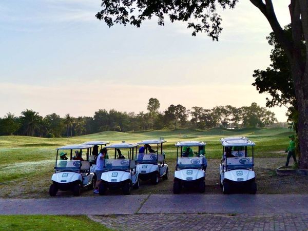 Greenwood Golf Club 5 people people golfing golf cart golf course and text