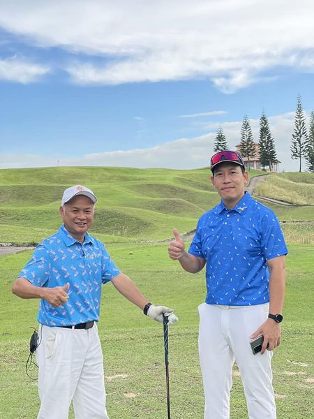2 people people standing golf course and grass 2 people people standing golf course and grass