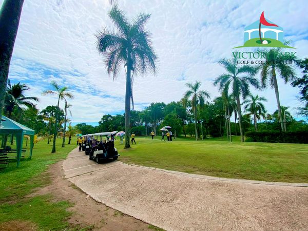 Victory Park Golf amp Country Club 3 people people golfing golf cart grass golf course and text